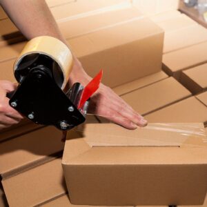 A person packing boxes with tapes