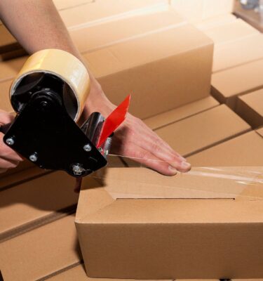 A person packing boxes with tapes